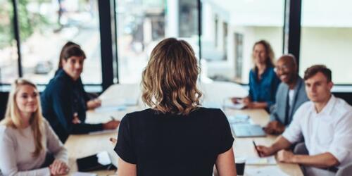 business woman addressing others during a meeting